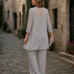 Evelyn embroidered three-piece pant set by THE WHITMORE FAMILY featuring a coordinated dress, pants, and top in vibrant colors.