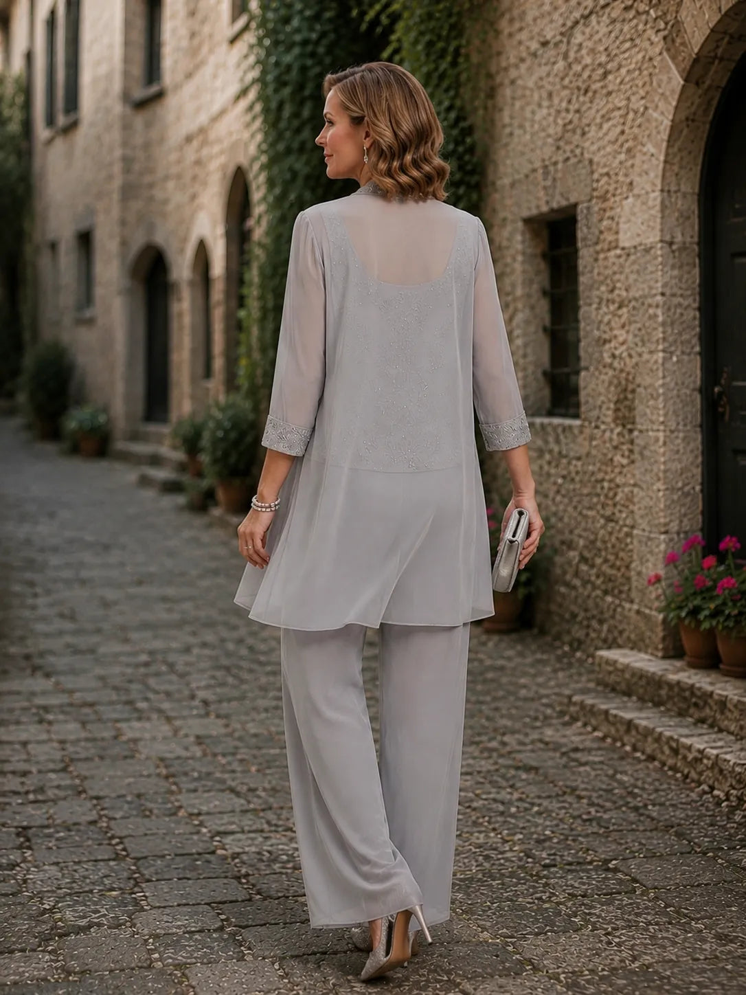 Evelyn embroidered three-piece pant set by THE WHITMORE FAMILY featuring a coordinated dress, pants, and top in vibrant colors.