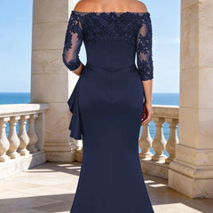 Elegant dark navy floor-length lace sleeve formal dress by THE WHITMORE FAMILY, showcasing intricate lace details and flowing silhouette.