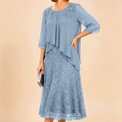 Dark navy lace overlay chiffon mother of the bride dress by THE WHITMORE FAMILY with elegant lace details and flowing chiffon fabric.