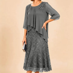 Dark navy lace overlay chiffon mother of the bride dress by THE WHITMORE FAMILY, featuring elegant lace details and flowing chiffon fabric.