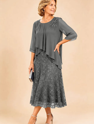 Dark navy lace overlay chiffon mother of the bride dress by THE WHITMORE FAMILY, featuring elegant lace details and flowing chiffon fabric.