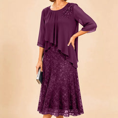 Dark navy lace overlay chiffon mother of the bride dress by THE WHITMORE FAMILY, featuring elegant lace details and flowing chiffon fabric.