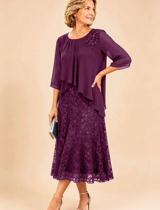 Dark navy lace overlay chiffon mother of the bride dress by THE WHITMORE FAMILY, featuring elegant lace details and flowing chiffon fabric.