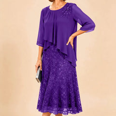 Dark navy lace overlay chiffon Mother of the Bride dress by THE WHITMORE FAMILY, elegant and flowing with intricate lace details.