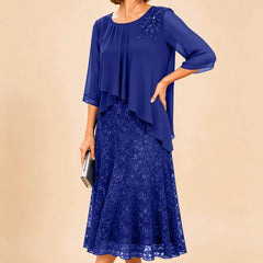 Dark navy lace overlay chiffon mother of the bride dress by THE WHITMORE FAMILY, featuring elegant lace details and flowing chiffon fabric.