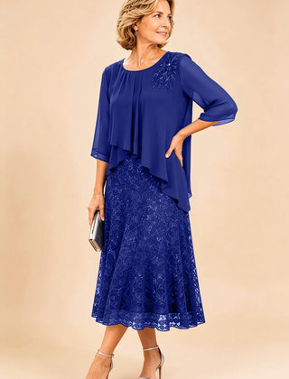 Dark navy lace overlay chiffon mother of the bride dress by THE WHITMORE FAMILY, featuring elegant lace details and flowing chiffon fabric.