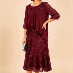 Dark navy lace overlay chiffon Mother of the Bride dress by THE WHITMORE FAMILY, featuring elegant lace details and flowing chiffon fabric.