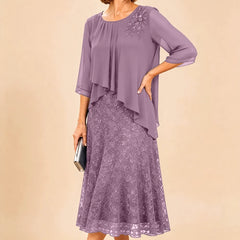 Dark navy lace overlay chiffon mother of the bride dress by THE WHITMORE FAMILY, featuring elegant lace details and flowing chiffon fabric.