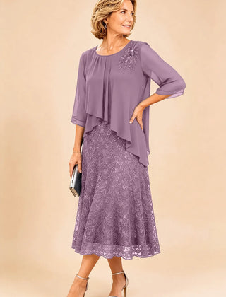 Dark navy lace overlay chiffon mother of the bride dress by THE WHITMORE FAMILY, featuring elegant lace details and flowing chiffon fabric.