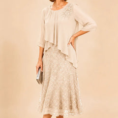Dark navy lace overlay chiffon mother of the bride dress by THE WHITMORE FAMILY, featuring elegant lace details and flowing chiffon fabric.