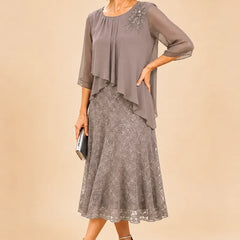 Dark navy lace overlay chiffon mother of the bride dress by THE WHITMORE FAMILY, featuring elegant lace details and flowing chiffon fabric.