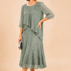Dark navy lace overlay chiffon mother of the bride dress by THE WHITMORE FAMILY, featuring elegant lace details and flowing chiffon fabric.