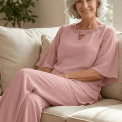Blush pink loose-fit formal pant dress set by THE WHITMORE FAMILY, featuring elegant tailored trousers and a matching top.