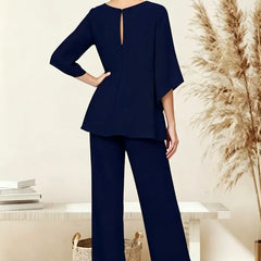 Sophisticated loose-fit formal pant dress set by THE WHITMORE FAMILY, shown from the back with tailored design and elegant silhouette.