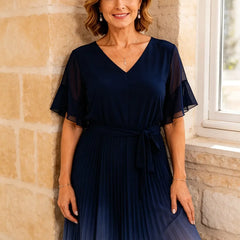 Dark navy tie waist chiffon midi dress with flutter sleeves by THE WHITMORE FAMILY, featuring a flowing, elegant design.