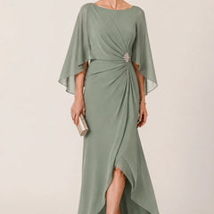 Dark navy chiffon dress by THE WHITMORE FAMILY featuring cape sleeves, wrap style, and a decorative brooch.