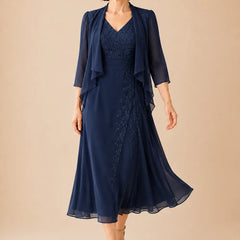 Dark navy V neck chiffon midi dress with lace detail by THE WHITMORE FAMILY, elegant and flowing for special occasions.