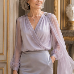 Lilac chiffon cape blouse by THE WHITMORE FAMILY, elegant wedding guest dress with flowing fabric and detailed design.