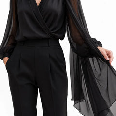 Black chiffon cape blouse from THE WHITMORE FAMILY, elegant wedding guest dress with flowy, romantic design.