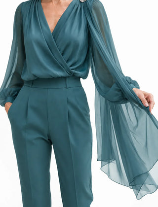 Elegant chiffon cape wedding guest blouse by THE WHITMORE FAMILY, featuring a soft, flowing design with a delicate silhouette.