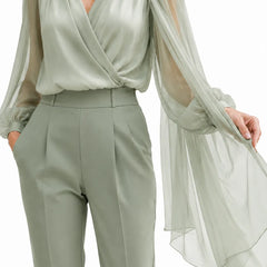 Romantic chiffon cape wedding guest blouse in dusty sage, elegant dress by THE WHITMORE FAMILY featuring flowing fabric and delicate design.