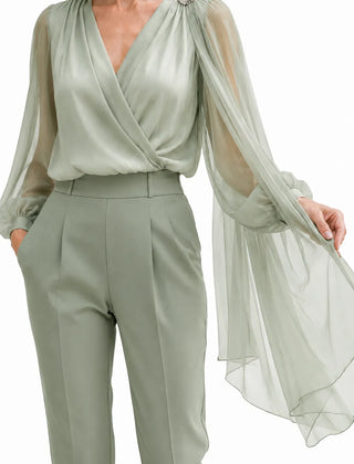Romantic chiffon cape wedding guest blouse in dusty sage, elegant dress by THE WHITMORE FAMILY featuring flowing fabric and delicate design.
