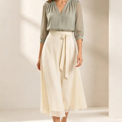 Refined chiffon wedding guest dress by THE WHITMORE FAMILY, featuring elegant flowy fabric and a sophisticated design.