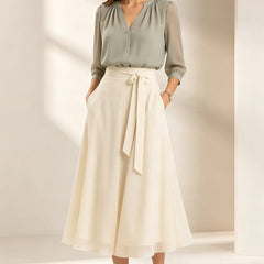 Refined chiffon wedding guest dress by THE WHITMORE FAMILY featuring elegant matcha green fabric and delicate detailing.
