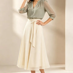 Refined chiffon wedding guest dress by THE WHITMORE FAMILY in matcha green, featuring elegant flowy fabric and a graceful silhouette.