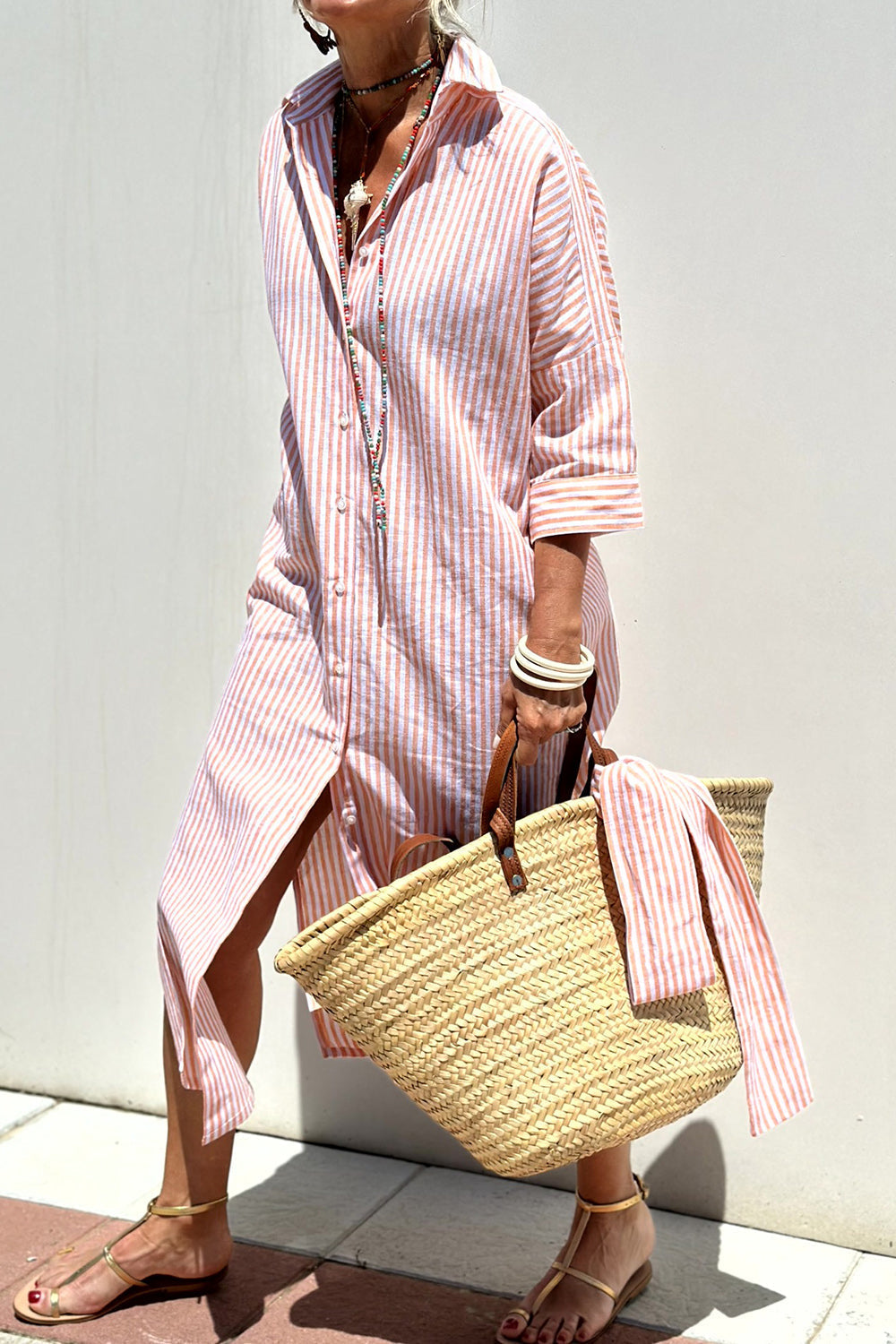 Pink striped shirt dress by THE WHITMORE FAMILY, featuring a classic, elegant design with comfortable fit and button-front style.