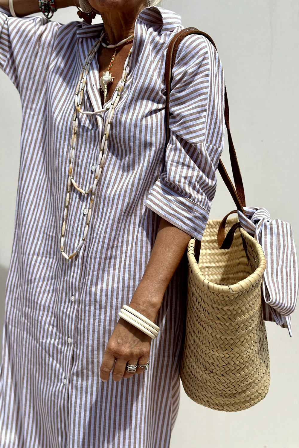 Pink Sophia striped shirt dress by THE WHITMORE FAMILY, featuring a classic design and comfortable fit, shown on a model.