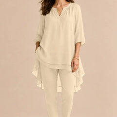 Elegant champagne-colored overlay pant dress from THE WHITMORE FAMILY, featuring a sophisticated design for formal occasions.