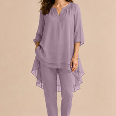 Elegant shadowarth Valora mother of the bride pant dress ensemble by THE WHITMORE FAMILY with a flowing overlay and floral accents.