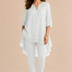 Elegant white overlay pant dress by THE WHITMORE FAMILY, featuring a sophisticated design perfect for formal occasions.