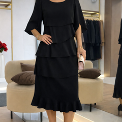 Black Patricia ruffle dress by THE WHITMORE FAMILY, elegant comfort dress with stylish ruffle details and a flattering fit.