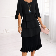 Black Patricia ruffle dress by THE WHITMORE FAMILY, elegant and comfortable dress with stylish ruffle details.