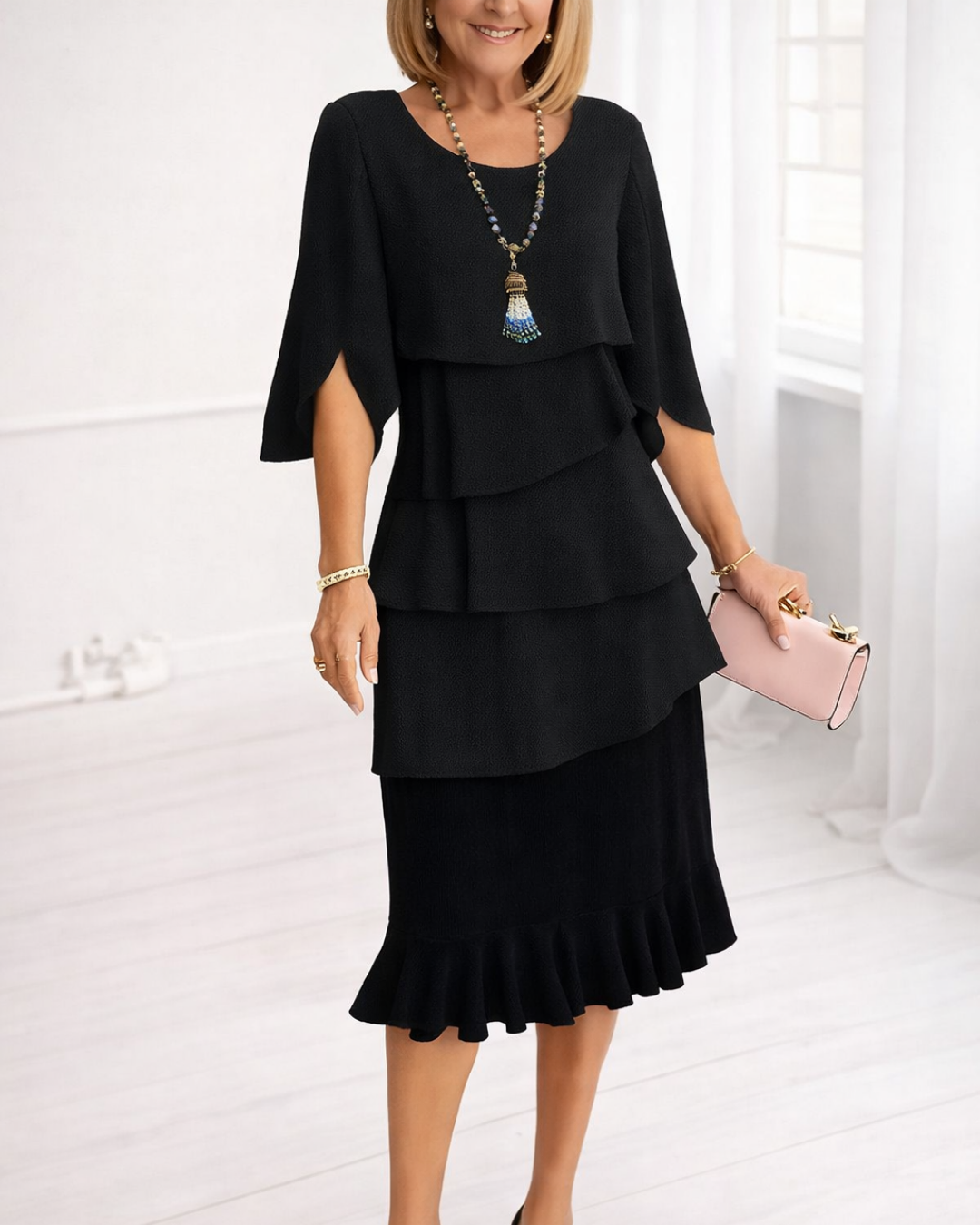 Black Patricia ruffle dress by THE WHITMORE FAMILY, elegant and comfortable dress with stylish ruffle details.