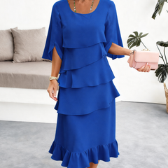 Black Patricia ruffle dress by THE WHITMORE FAMILY featuring elegant, flowing fabric and stylish ruffle details.