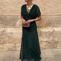 Bottle green Emma elegant maxi party dress by THE WHITMORE FAMILY, featuring a flowing design and sophisticated style.