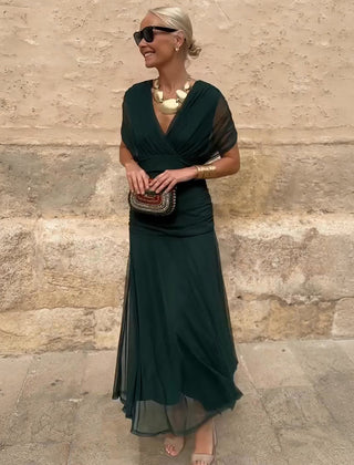 Bottle green Emma elegant maxi party dress by THE WHITMORE FAMILY, featuring a flowing design and sophisticated style.