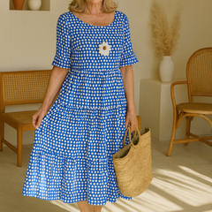 Sable midi dress by THE WHITMORE FAMILY featuring a flowing silhouette and brown fabric, perfect for stylish occasions.