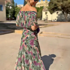 Hendrika Coral Glow evening dress by THE WHITMORE FAMILY, elegant sleeveless dress with floral garden design and flowing fabric.