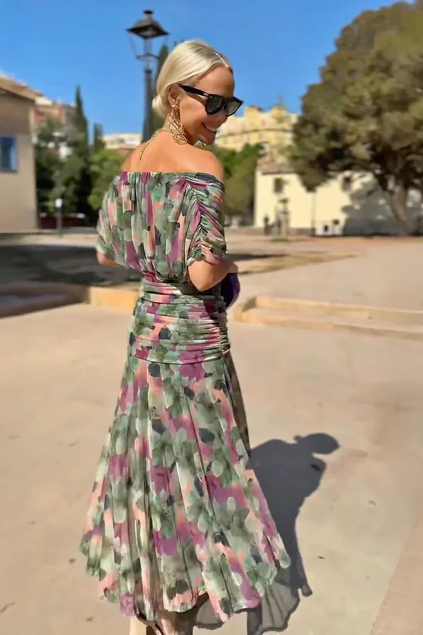 Hendrika Coral Glow evening dress by THE WHITMORE FAMILY, elegant sleeveless dress with floral garden design and flowing fabric.