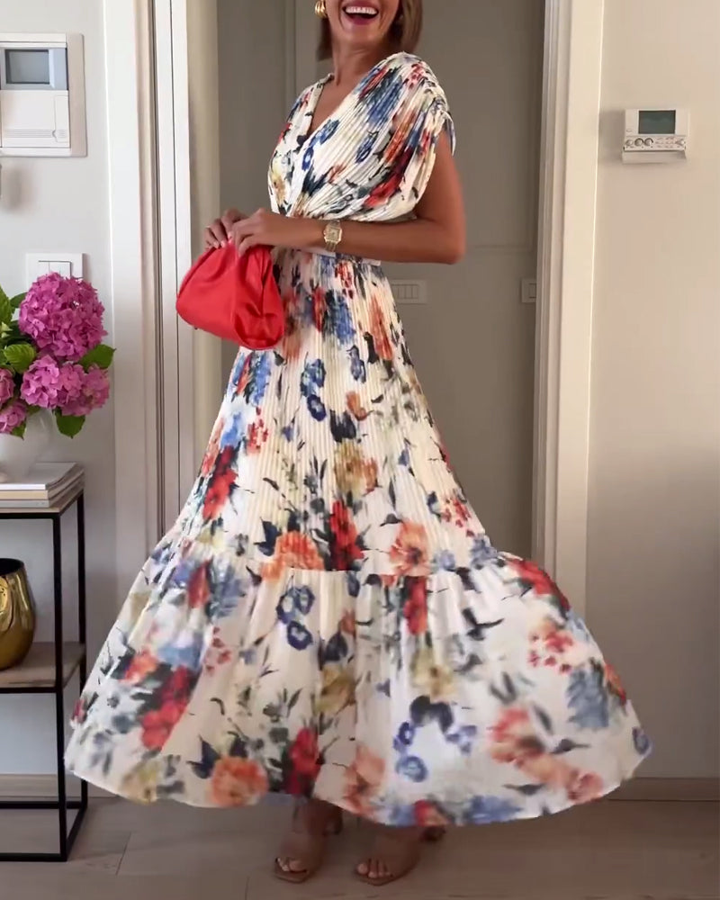 Elegant Florelle floral dress by THE WHITMORE FAMILY featuring a vibrant pattern and flowing fabric, perfect for special occasions.