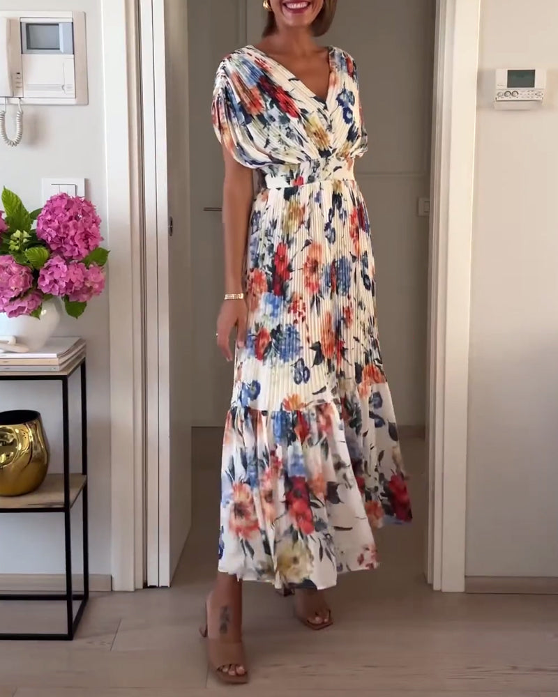 Elegant floral dress by THE WHITMORE FAMILY featuring a fitted silhouette and delicate floral pattern, perfect for special occasions.