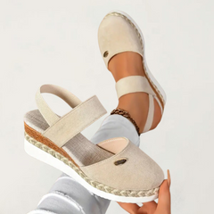 Beige Antonia™ ELUXOR orthopedic sandals by THE WHITMORE FAMILY, featuring supportive design and comfortable straps.