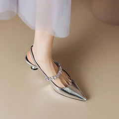 Silver flat sandals from THE WHITMORE FAMILY's Isabelle collection, elegant casual pumps with open-toe design and minimalistic style.