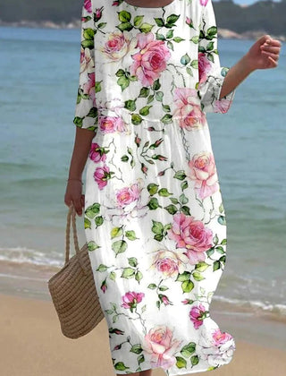 Floral Kira Timeless Chic Dress by THE WHITMORE FAMILY displayed on a dress form, showcasing elegant design and vibrant floral pattern.