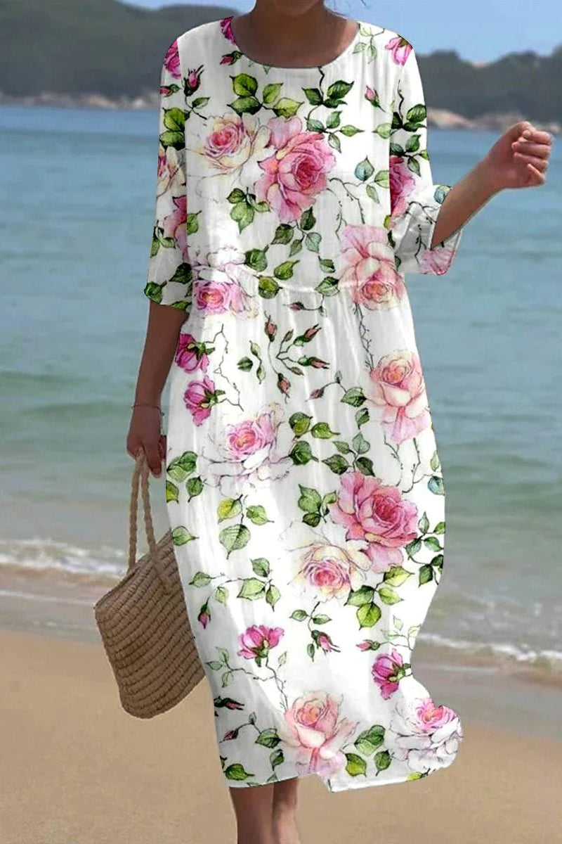 Floral Kira Timeless Chic Dress by THE WHITMORE FAMILY displayed on a dress form, showcasing elegant design and vibrant floral pattern.